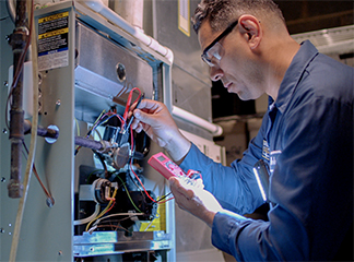 contractor performing maintenance on furnace